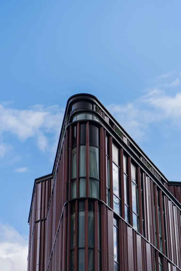 Commercial office building with a curved corner and rows of windows