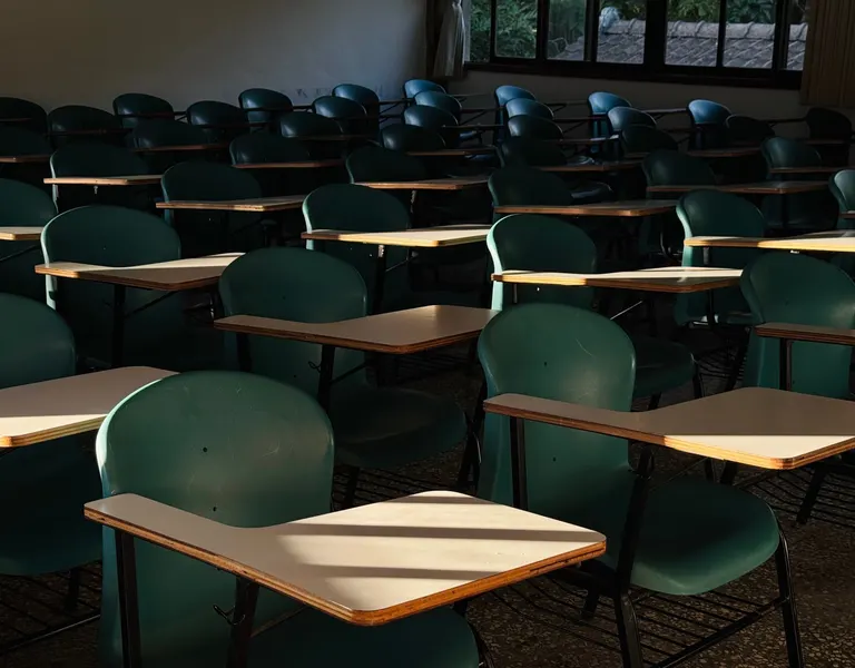 Sunlight across desks in an empty classroom