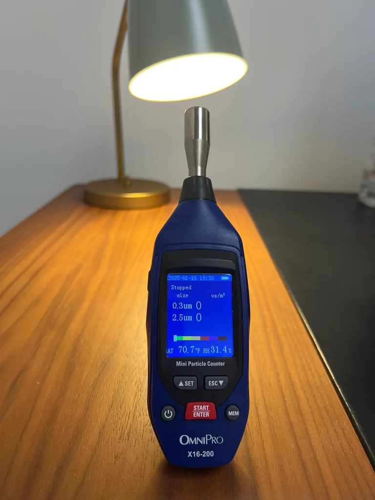 Handheld air particle counter on table view 1