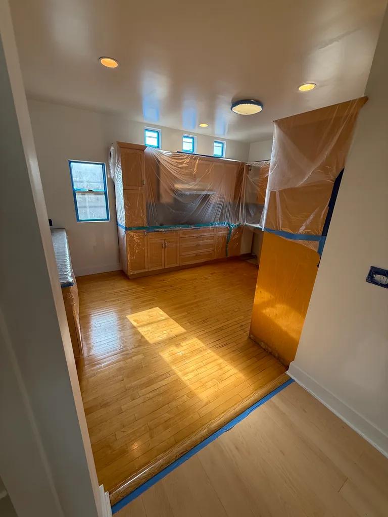 Kitchen cabinets protected with plastic sheeting
