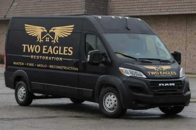 Black Two Eagles Restoration van with gold company branding